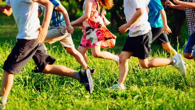 Children's legs running outside