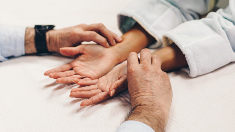 acupressure therapist massaging patient's wrist