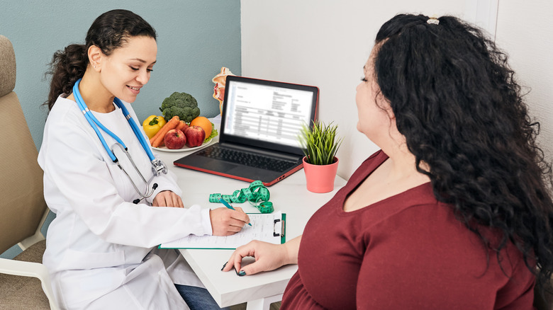 obese woman talking to her doctor