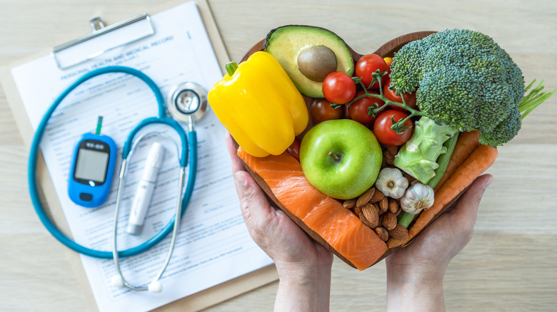 bowl of healthy food next to a medical chart