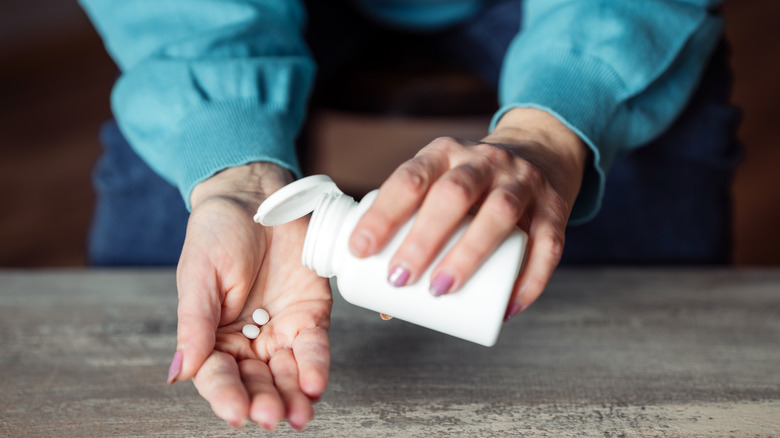 Woman holding pill bottle