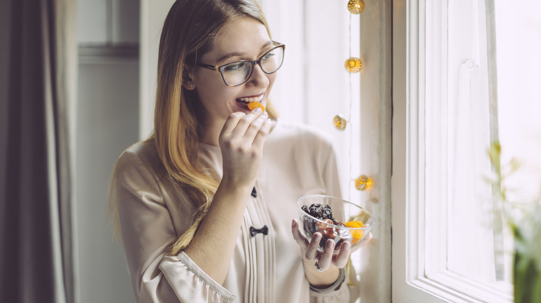 Woman eating fruit