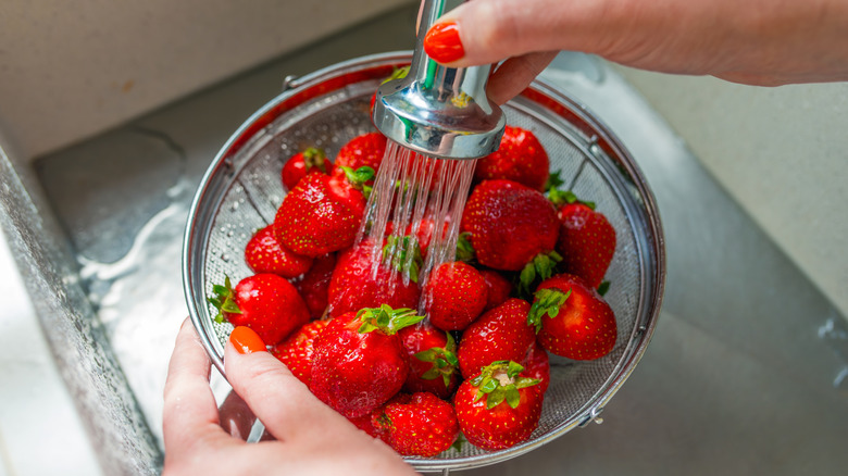 close up of strawberries being rinsed
