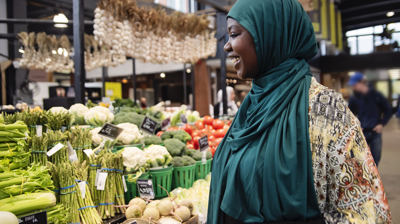 laughing woman at local farmer's market stand