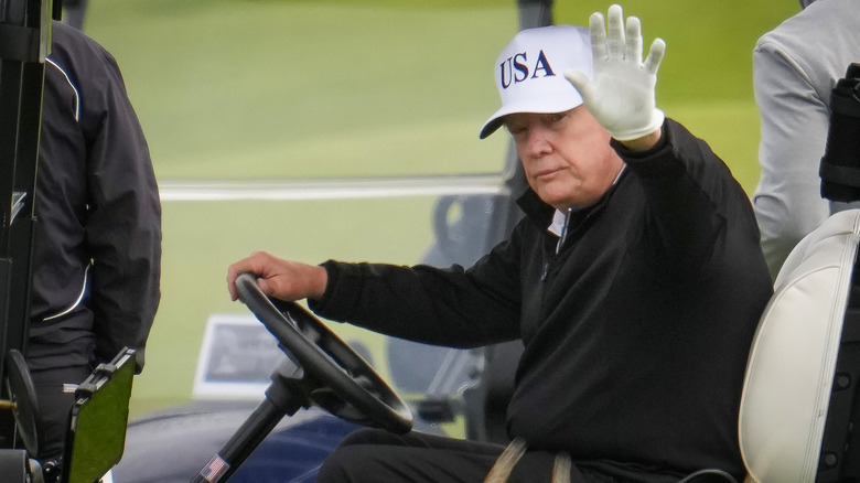 Donald Trump in a golf cart at his Scotland golf course in 2025