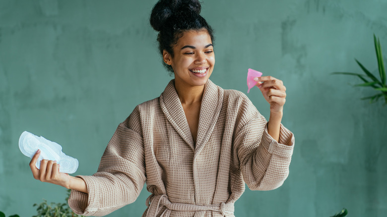 woman holding menstrual cup