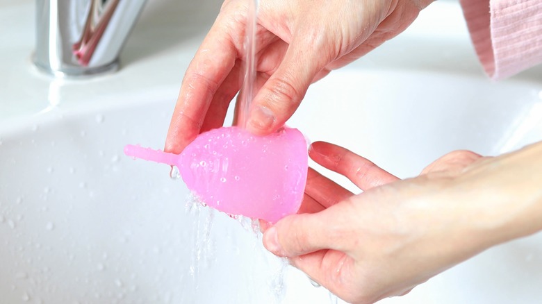 woman rinsing out menstrual cup 