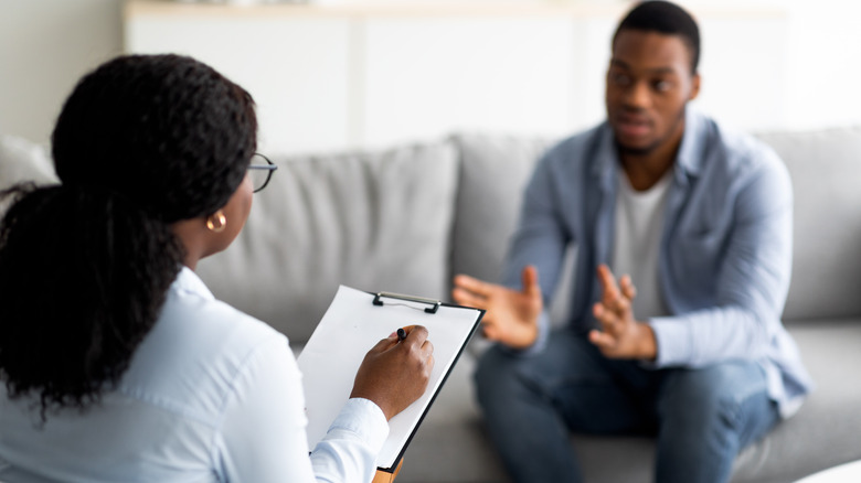 man sitting talking to therapist