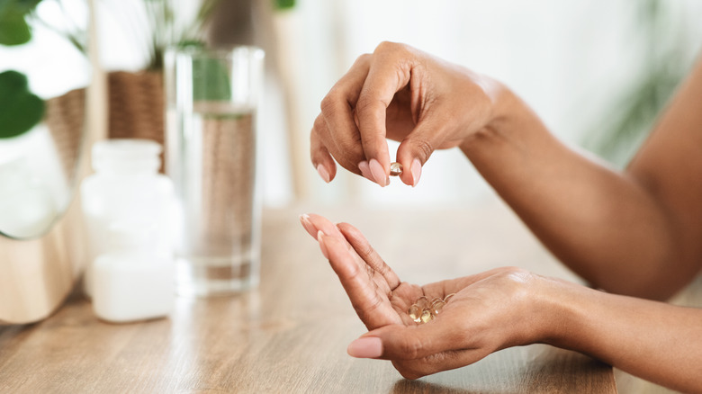 woman holding pill in hand