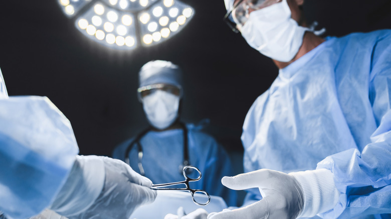 team of medical surgeons in operating room