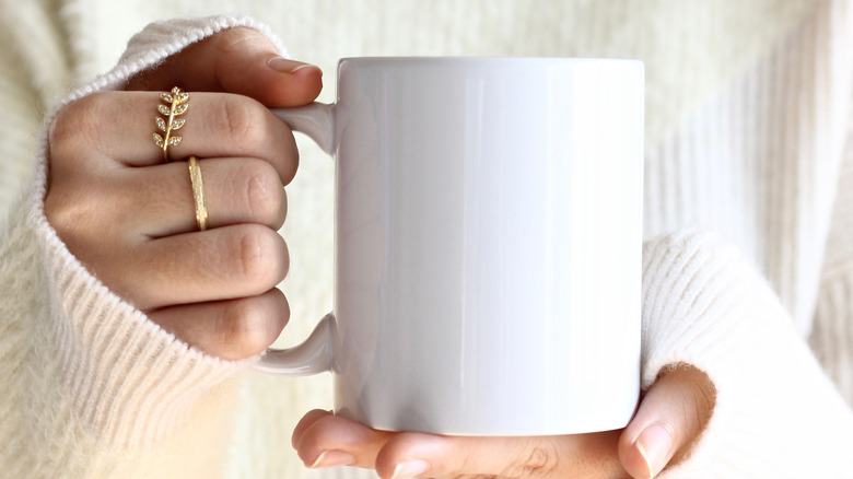 woman's hand holding cup