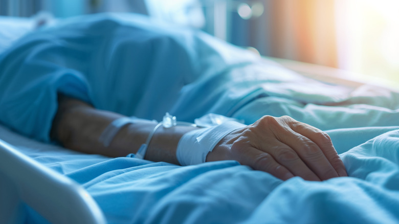 A person lying in a hospital bed