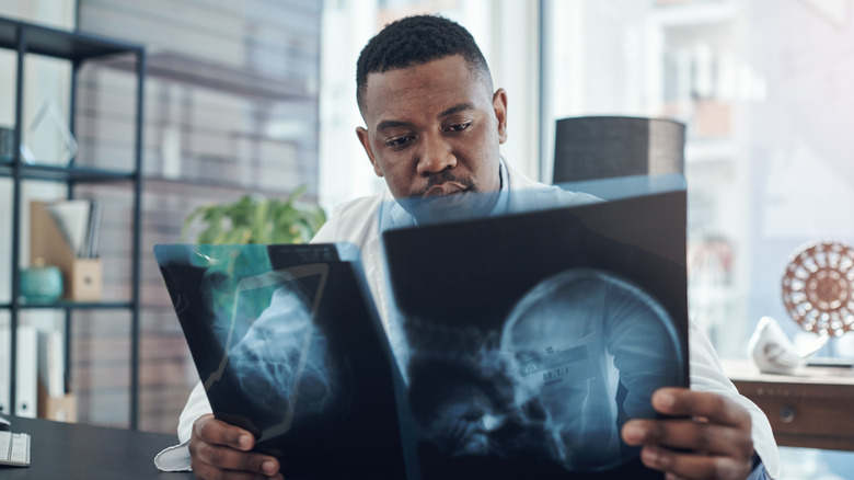 A doctor studying x-ray scans