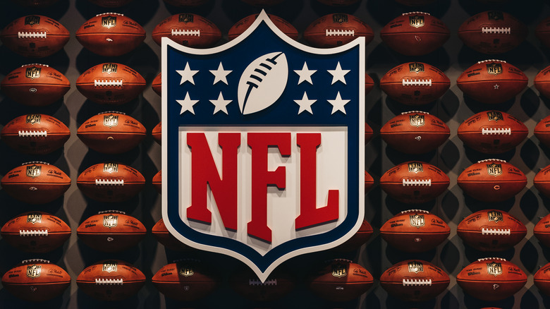 The NFL logo against a backdrop of footballs