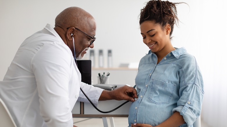 Pregnant woman with doctor