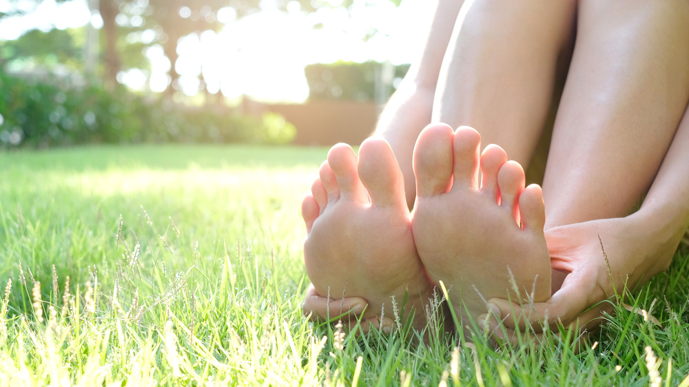 woman's foot on grass