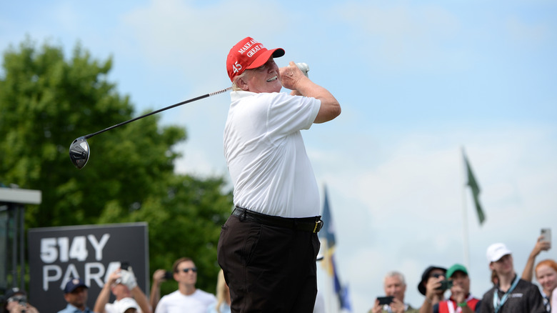 Donald Trump swinging a golf club on course