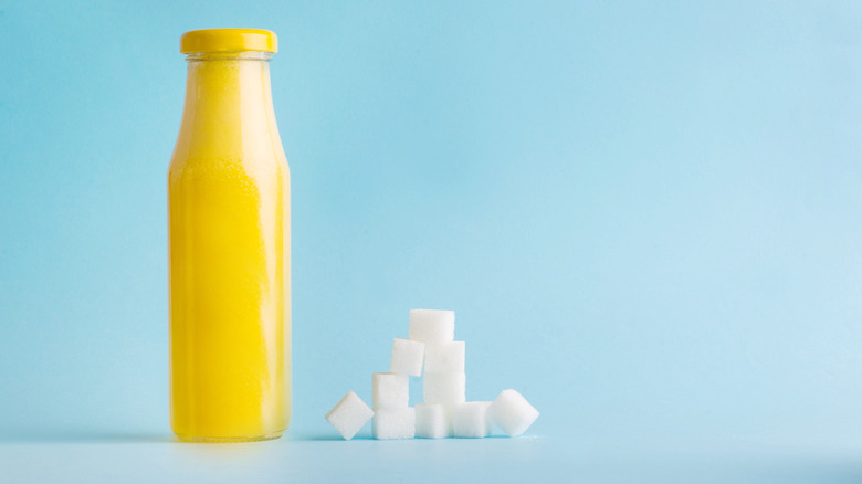 Sugar cubes stacked next to a condiment bottle