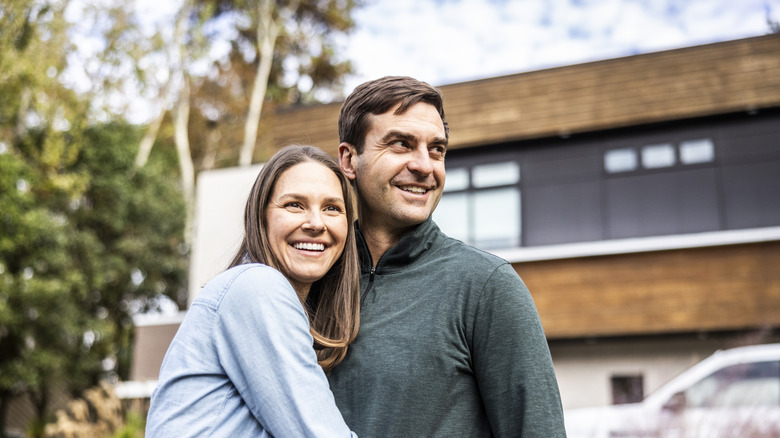 man and woman embracing outdoors