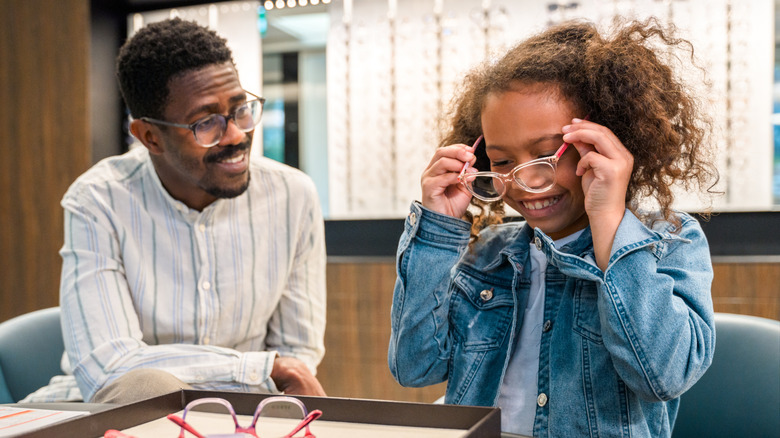 Young girl trying on glasses