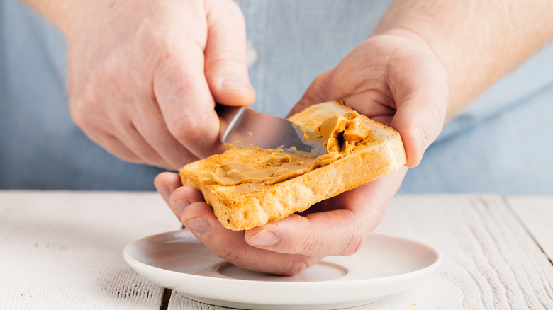 spreading peanut butter