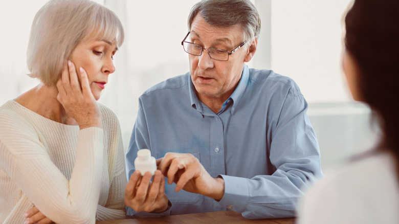woman and man questioning prescription with provider
