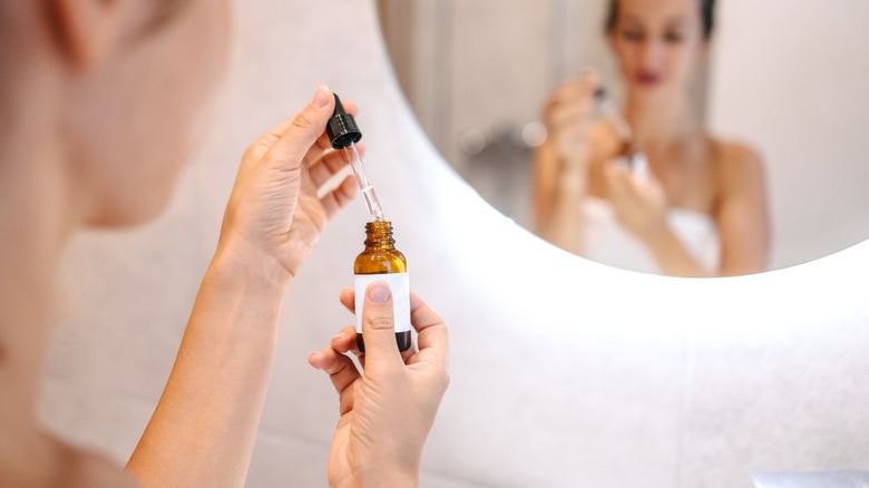 Woman holding essential oil vial