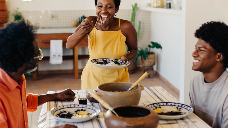 family of three at table eating black beans