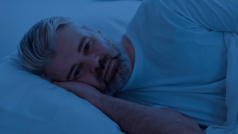 Man laying awake in bed