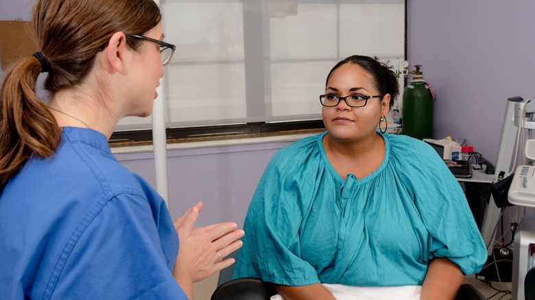 Abortion provider speaks to patient in office