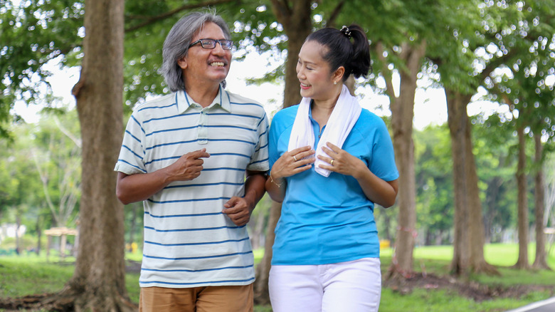 Man and woman smiling going on walk outside