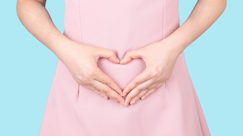 woman with hands on stomach