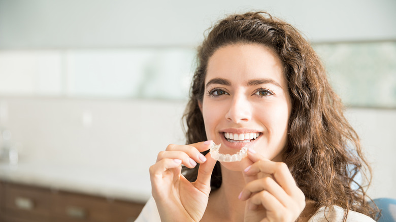 Woman holding a mouthguard