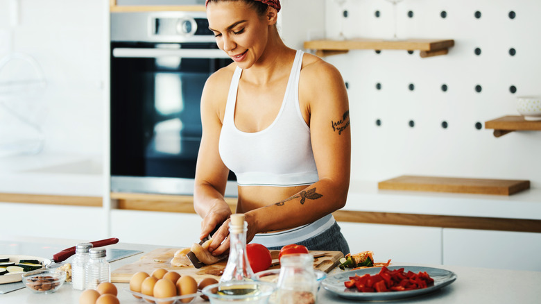 Athletic woman preparing meat for cooking