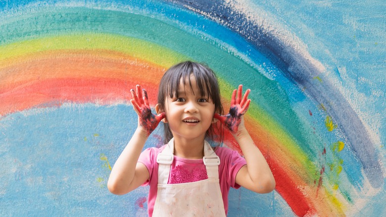 Child in front of rainbow