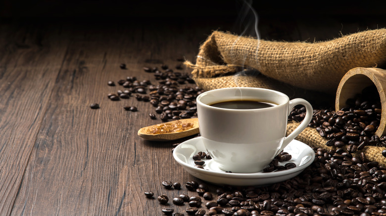 coffee with coffee beans on wooden plank