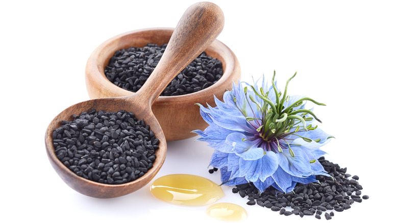 Nigella sativa flower with Black cumin seeds and oil