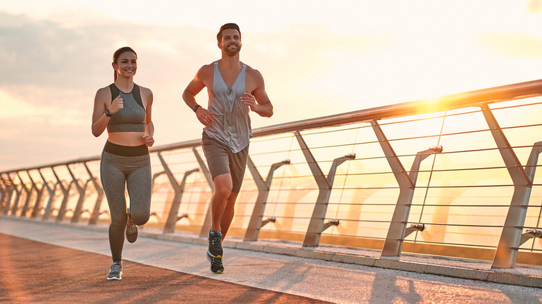 Woman and man running outside 