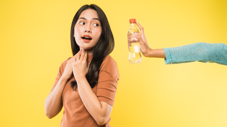 Asian woman being offered water