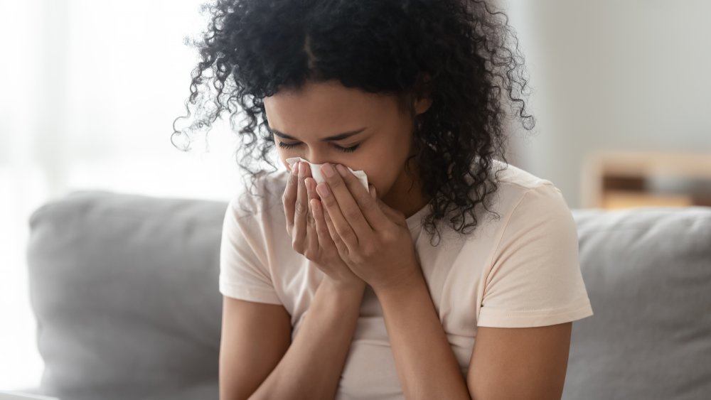 woman sneezing