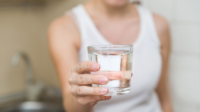 woman holding glass of water