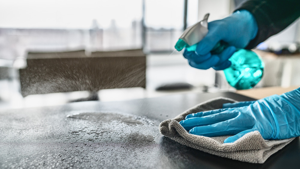 Person disinfecting a counter