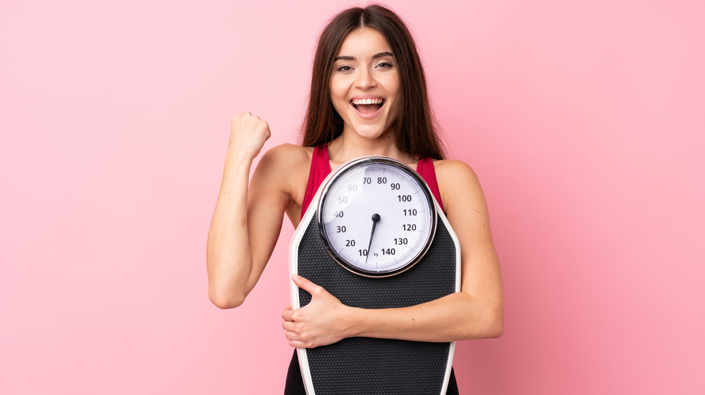 woman holding scale