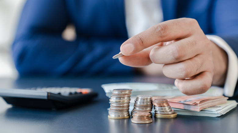 Man holding coin with money