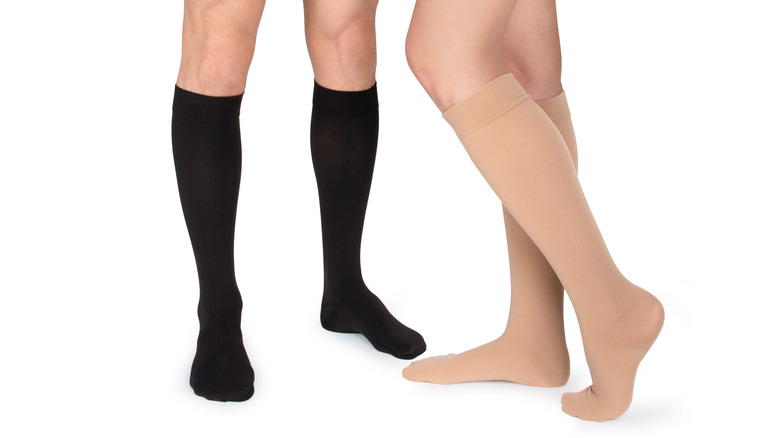 A pair of tan and black compression socks 