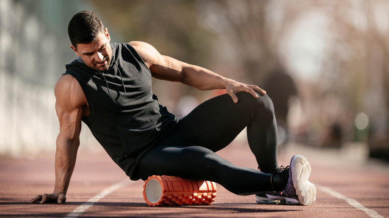 man using a foam roller