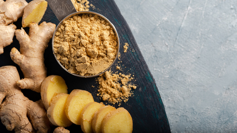 Ginger root and powdered ginger on a cutting board