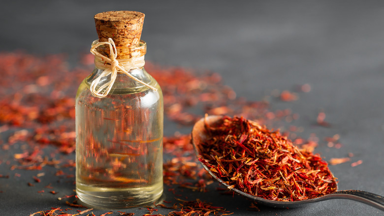 a glass jar gilled with saffron and oil 