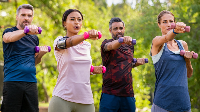 Adults working out with dumbbells