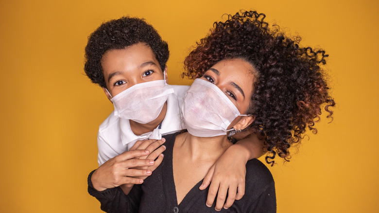 Mother and child wearing mask.